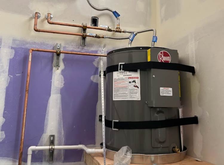 A heavy-duty Rheem water heater professionally installed with secure earthquake strapping and clean copper lines, providing high-performance hot water and peace of mind for your property.
