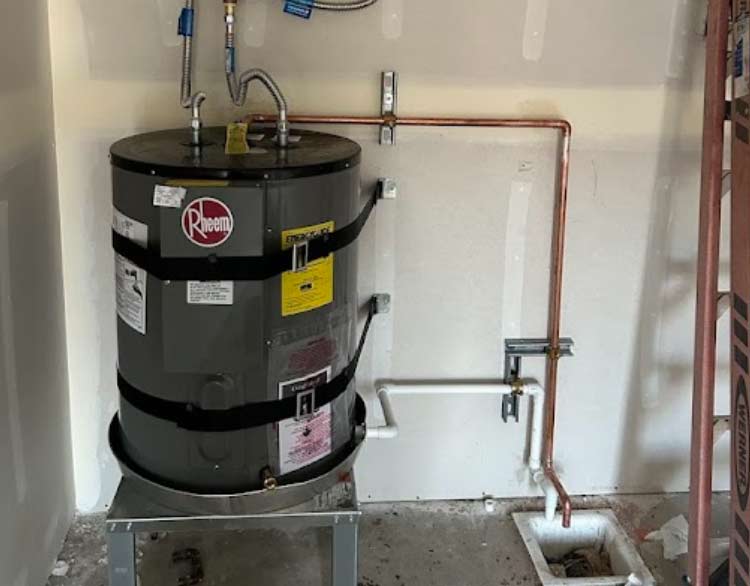 A heavy-duty Rheem water heater professionally installed with secure earthquake strapping and clean copper lines, providing high-performance hot water and peace of mind for your property.